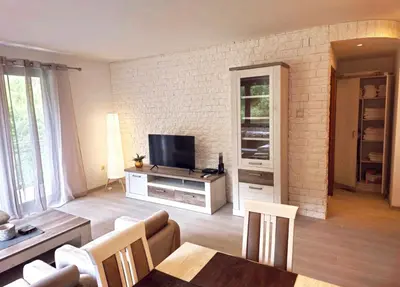 a living room with a couch and a television at A&A Apartment in Blue Horizon Przno with pool in Budva