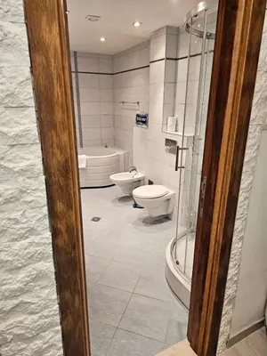a bathroom with two toilets and a tub and a shower at A&A Apartment in Blue Horizon Przno with pool in Budva