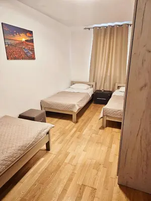 a room with two beds and a wooden floor at A&A Apartment in Blue Horizon Przno with pool in Budva