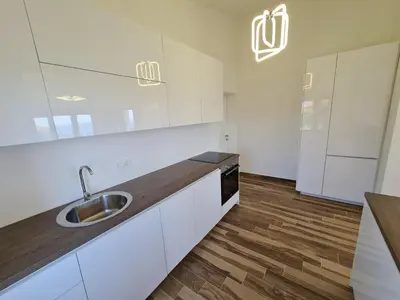 a kitchen with white cabinets and a sink at Luxury Penthouse with panoramic view in Ulcinj