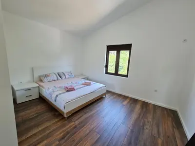 a bedroom with a bed and a wooden floor at Luxury Penthouse with panoramic view in Ulcinj