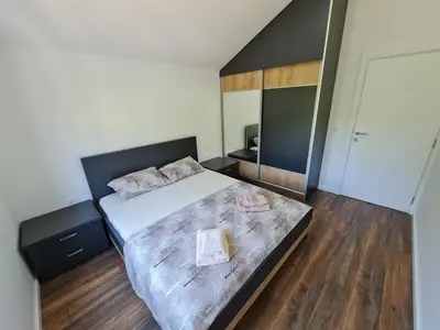 a bedroom with a large bed and a large mirror at Luxury Penthouse with panoramic view in Ulcinj