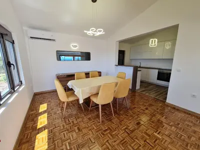 a kitchen and dining room with a table and chairs at Luxury Penthouse with panoramic view in Ulcinj