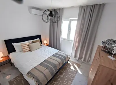 a bedroom with a large bed and a window at Villa Olive Hill in Dobra Voda