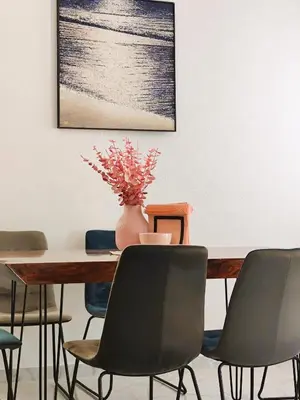 a dining room table with chairs and a vase on it at Villa Olive Hill in Dobra Voda
