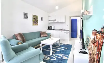 a living room with a blue couch and a table at Apartment ANA in Bar