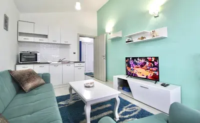 a living room with a couch and a tv at Apartment ANA in Bar