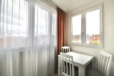 a white table and chairs in a room with a window at Apartment ANA in Bar