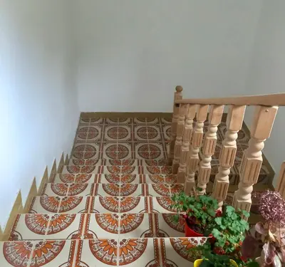 a table with plates on it with a staircase at Konak Ugnji-Village in Cetinje