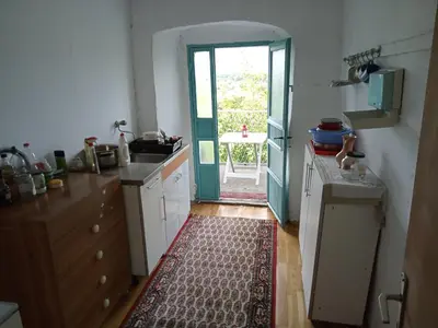 a kitchen with a door leading to a patio at Country stone house Kovacevic in Danilovgrad