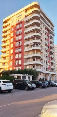 a large building with cars parked in a parking lot at Stan u centru BEST VIEW in Bar