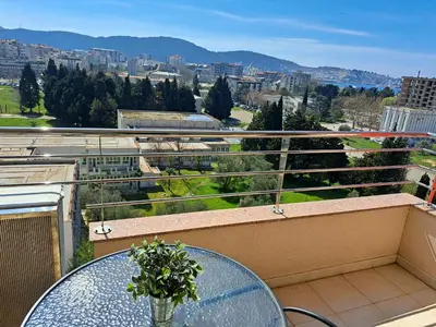 a balcony with a table and a view of a city at Stan u centru BEST VIEW in Bar
