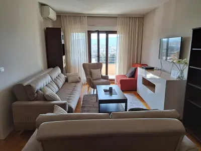 a living room with couches and chairs and a tv at Stan u centru BEST VIEW in Bar
