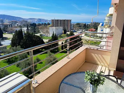 a balcony with a table and a view of a city at Stan u centru BEST VIEW in Bar