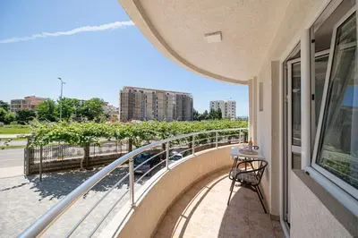 a balcony with a table and a view of a street at Villa Dana in Bar