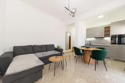 a living room with a couch and a table with chairs at Villa Dana in Bar