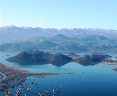 a view of a lake with mountains in the background at The Island of Prevlaka in Prevlaka