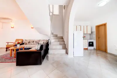 a living room with a couch and a table at Holiday Home Adria in Dobra Voda