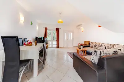 a living room with a couch and a table at Holiday Home Adria in Dobra Voda