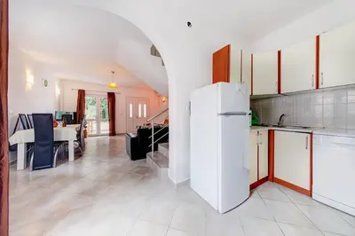 a kitchen with a white refrigerator in a room at Holiday Home Adria in Dobra Voda