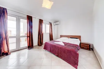 a bedroom with a bed and a large window at Holiday Home Adria in Dobra Voda