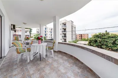 a balcony with a table and chairs on it at Holiday Home Adria in Dobra Voda