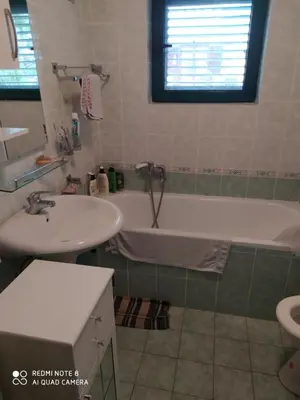 a bathroom with a tub and a sink and a bath tub at Apartman Podkošljun in Budva