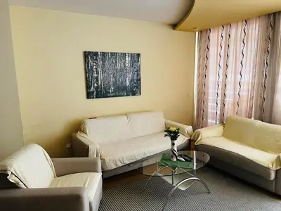 a living room with two couches and a table at 'M&M' two bedroom apartment in center of Budva in Budva