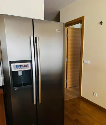 a stainless steel refrigerator with a tv on top of it at 'M&M' two bedroom apartment in center of Budva in Budva
