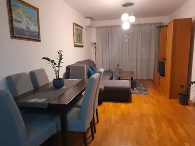 a living room with a table and chairs and a television at Marija in Bar