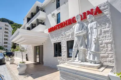 a statue of two men outside of a building at Montenegrina Hotel & SPA All-Inclusive in Becici