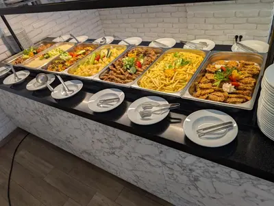 a buffet line with many different types of food at Montenegrina Hotel & SPA All-Inclusive in Becici