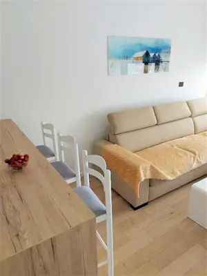 a living room with a table and a couch at SOHO JC Apartment in Bar