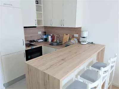 a kitchen with a wooden counter top and a sink at SOHO JC Apartment in Bar