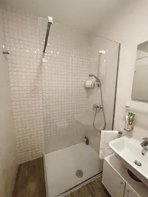a bathroom with a shower and a sink at Vista City Apartment in Podgorica