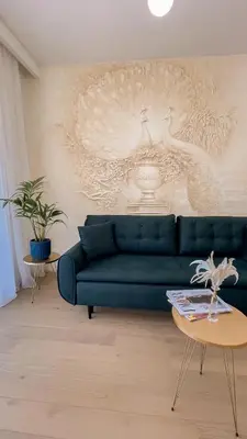 a living room with a blue couch and a table at Royal Residence Apartment in Budva