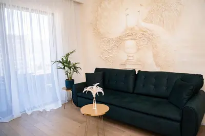 a living room with a green couch and a table at Royal Residence Apartment in Budva