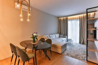 a living room with a table and a couch at Royal Residence Apartment in Budva