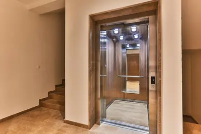 a wooden door in a hallway with stairs at Royal Residence Apartment in Budva