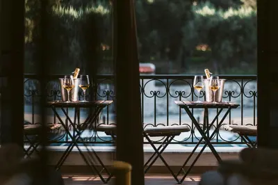 a table with glasses of wine on a balcony at Carolea Villas - Boutique Hotel & Villas in Ulcinj