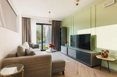 a living room with a couch and a television at Carolea Villas - Boutique Hotel & Villas in Ulcinj