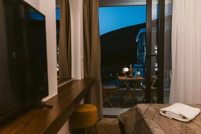 a bedroom with a large window with a view of a room at Carolea Villas - Boutique Hotel & Villas in Ulcinj