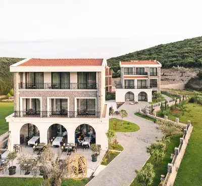 an aerial view of a building with tables and chairs at Carolea Villas - Boutique Hotel & Villas in Ulcinj