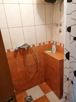 a bathroom with a shower with a shower head at Apartmani Ljumović Budva in Budva