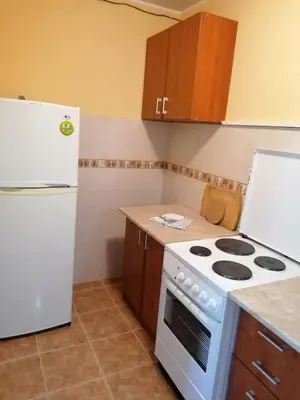 a kitchen with a white stove and a refrigerator at Apartmani Ljumović Budva in Budva