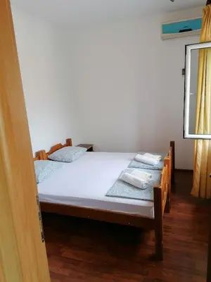 a bedroom with a bed with towels on it at Apartmani Ljumović Budva in Budva