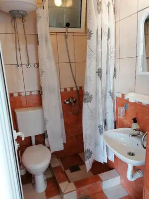 a bathroom with a toilet and a sink at Apartmani Ljumović Budva in Budva