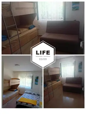 a room with two bunk beds and a living room at Anika in Sutomore