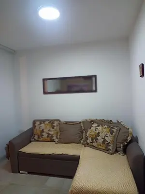 a couch sitting in a living room with pillows at Anika in Sutomore