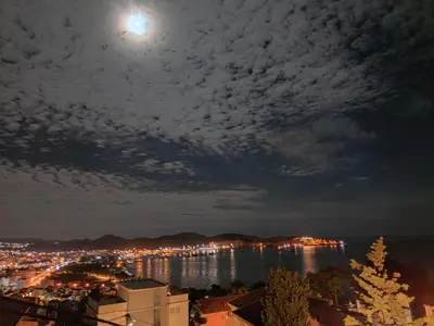 a view of a city at night with a full moon at Apartmani Durovic in Bar
